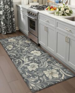 Gray floral kitchen runner rug in front of white cabinets and stainless steel stove