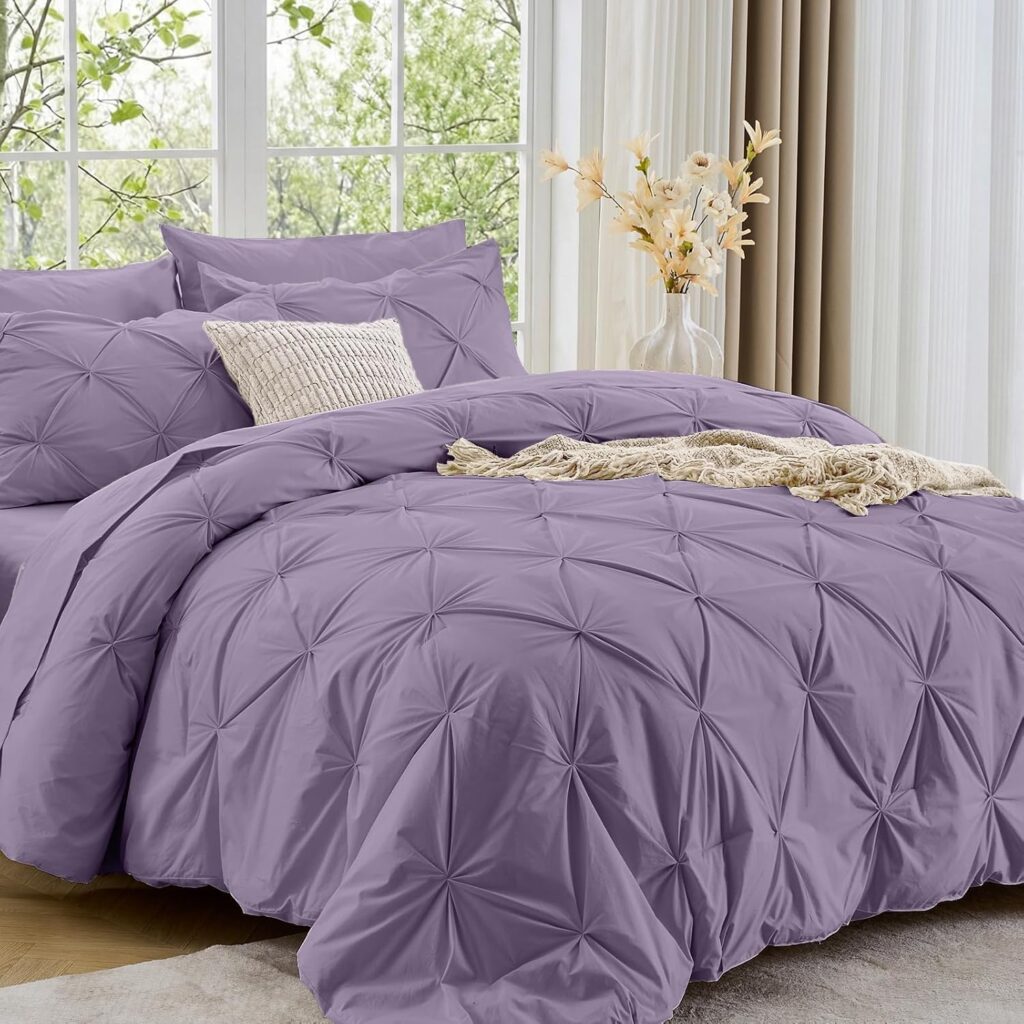 Purple textured comforter set on bed with matching pillows in bright bedroom