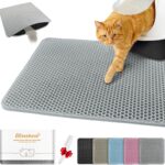 Cat stepping out of litter box onto gray litter catching mat with mesh texture