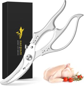 Stainless steel kitchen shears with storage box and raw chicken on cutting board