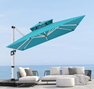 canti-levered umbrella in aqua with ocean in the background and patio seating underneath