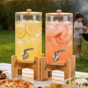 two party drink coolers with taps on wooden bases with one filled with lemonade and one filled with peachade with a boy at a charcoal grill