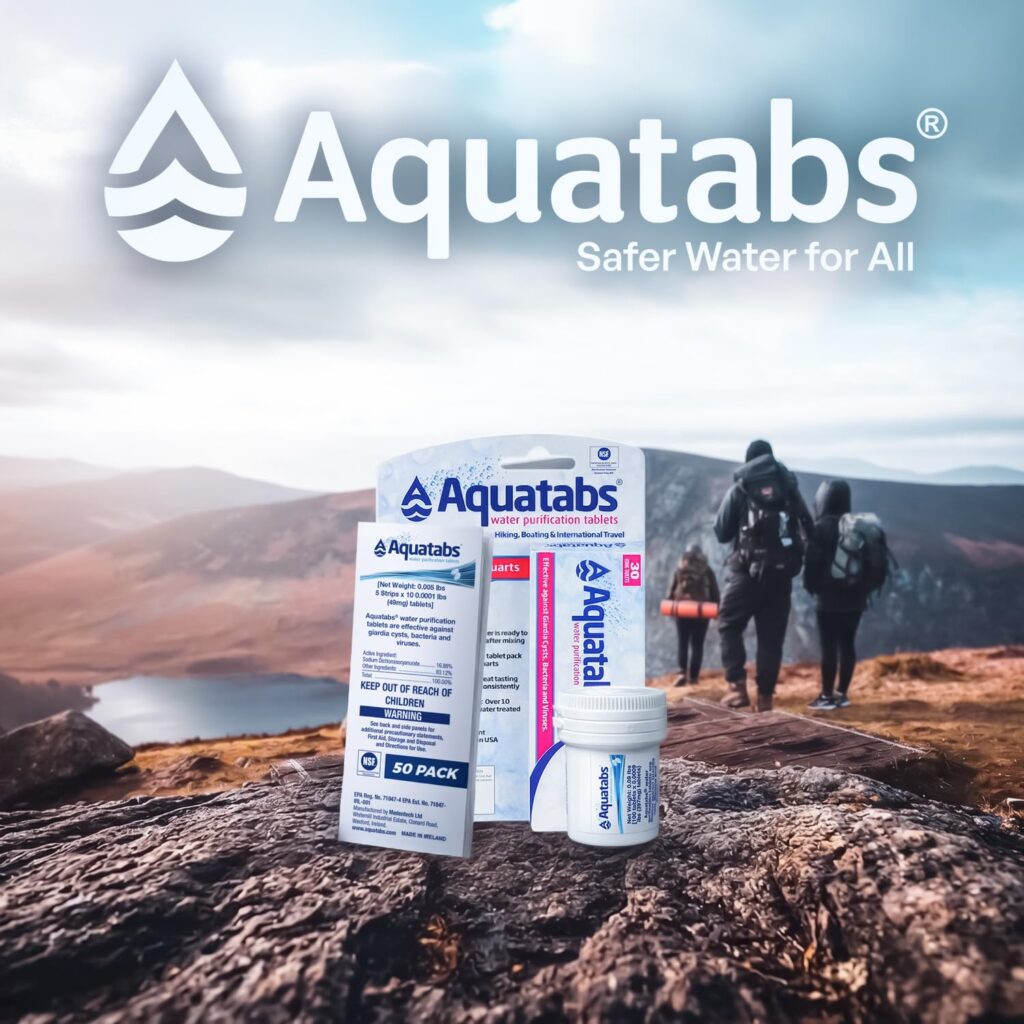 aquatabs package on mountain top with family hiking in the background